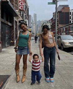 two women and a child are walking down the street