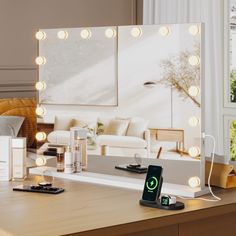 an electronic device on a desk in front of a mirror with light bulbs around it