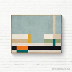 a painting hanging on the wall next to a white brick wall with an abstract design