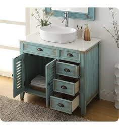 a bathroom vanity with drawers and a sink in the corner, next to a mirror