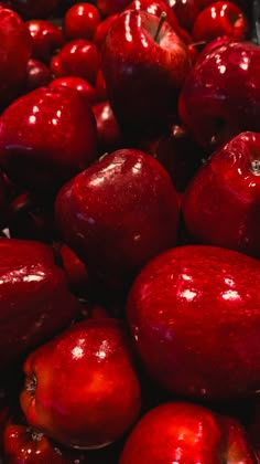 a pile of red apples sitting next to each other