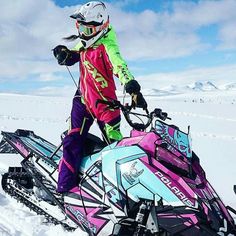 a person on a snowmobile in the snow with skis and poles attached to it