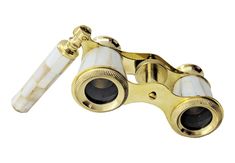 a pair of binoculars sitting on top of a white table next to a gold plated object