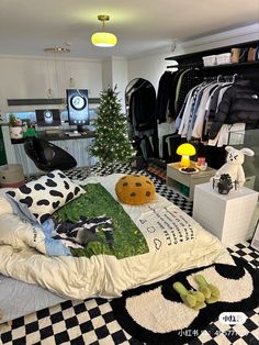 a bedroom with black and white checkerboard flooring, green accents and lots of clothes