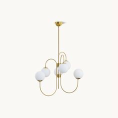 a brass chandelier with five white glass balls hanging from the bottom, on an off - white background