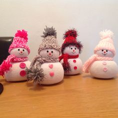 five snowmen are lined up on a table