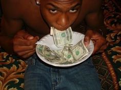 a man holding a plate with money in it