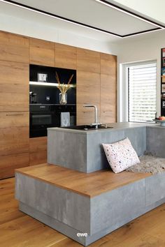 a modern kitchen and living room with wood flooring