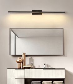 a bathroom with a vanity, mirror and towel rack