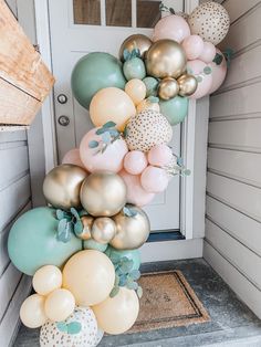 a bunch of balloons are hanging on the front door