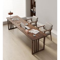 a wooden table with chairs and a laptop on it next to a book shelf filled with books