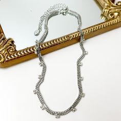 Pictured is a double, silver box chain necklace with clear crystal charm. This necklace is pictured partially laying on a gold mirror on a white background. Giddy Up Glamour, Tennis Necklace, Crystal Collection, Box Chain, Lobster Claw, Sale Items, Tennis, Silver Tone, Chain