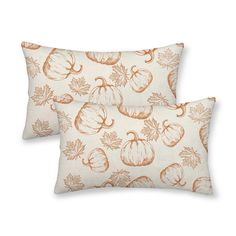 two pillows with pumpkins and leaves on them