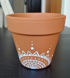 a clay flower pot sitting on top of a table