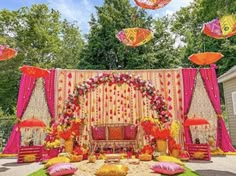 an outdoor wedding setup with umbrellas and decorations