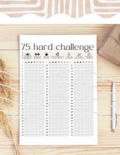 the 75 hard challenge printable is displayed on a table