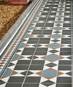 a black and white tiled floor next to a planter