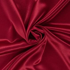 a close up view of the red fabric that is very soft and shiny, it looks like