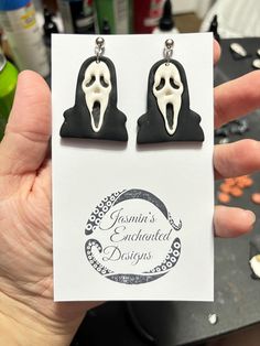 a pair of black and white ghost earrings