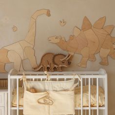 a baby crib with stuffed animals on the wall