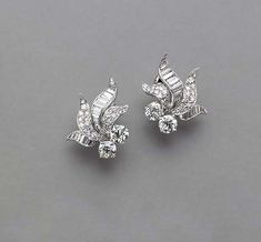 A PAIR OF DIAMOND AND PLATINUM EAR CLIPS