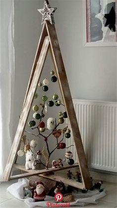 a wooden christmas tree with ornaments in it