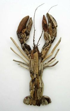 a lobster made out of wood sticks on a white background