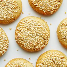 sesame seed cookies are arranged on a white surface