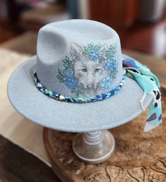 Felt/wool hat hand burned with wolf pattern. Hand colored and hand made band. Adjustable and nice quality. beautiful soft heathered blue color ... fun for any event, awesome gift! Artisan Hats For Winter Country Events, Artisan Wide Brim Winter Fedora, Adjustable Artisan Fedora For Winter, Artisan Adjustable Fedora For Winter, Artisan Wide Brim Winter Hat, Bohemian Fur Felt Fedora With Short Brim, Artisan Brimmed Felt Hat For Winter, Winter Festival Fedora With Curved Brim, Artisan Adjustable Felt Hat For Winter