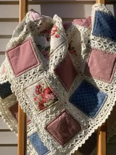 a crocheted blanket on top of a wooden chair