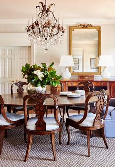 a dining room table with chairs and a chandelier