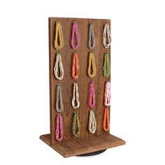 a wooden display with several pairs of earrings on it