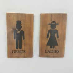 two wooden signs with the words gents and ladies on them