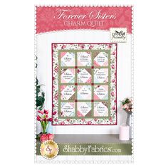 a quilted wall hanging with the words, flowers and hearts on it in pink