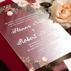 the wedding stationery is laid out on top of each other, including a rose