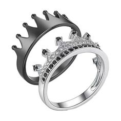 a silver ring with black and white diamonds on it, set in the shape of a crown