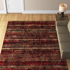 a living room with a couch and rug on the floor