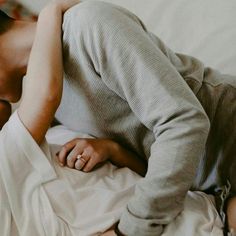 a woman laying on top of a bed next to a man