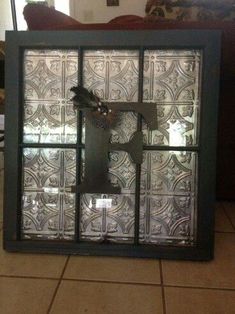 a glass window with a clock on the front and side panels that have been cut out to look like an intricate pattern