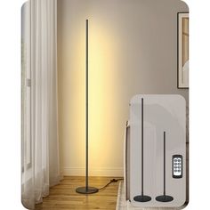 the floor lamp is next to an air purificater and remote control