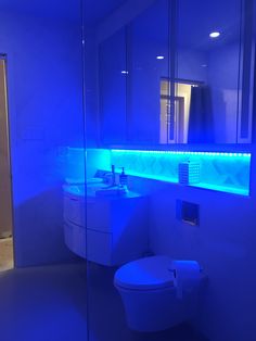 a bathroom with blue lights on the wall