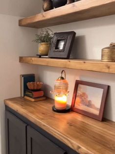 some shelves with pictures and candles on them