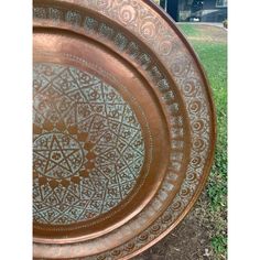 a large metal plate sitting on top of a grass covered field