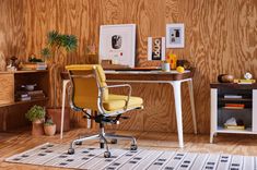 an office with wood paneling and yellow chair in front of a white rug on the floor