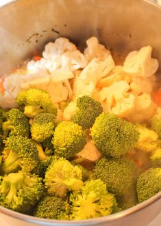 broccoli and cauliflower are being cooked in a pot on the stove