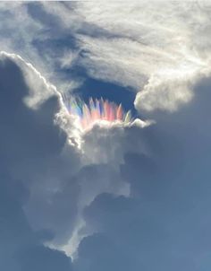 the rainbow is visible in the clouds as it appears to be coming out of the sky