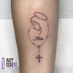 a woman's leg with a tattoo on it that says mary and a cross