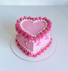 a heart shaped cake sitting on top of a white plate