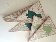 three paper dinosaurs are hanging from the ceiling with string attached to each one's sides