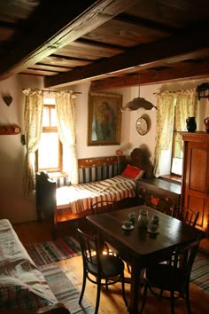 a living room filled with furniture and a wooden table